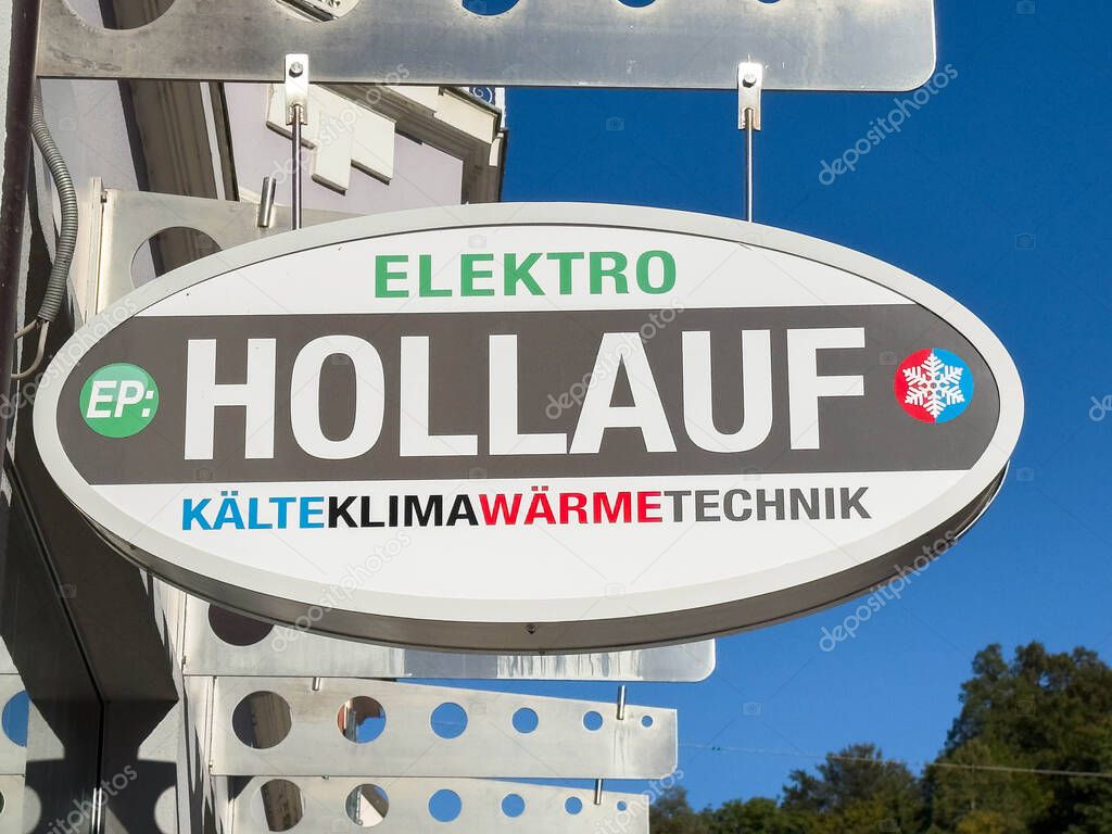 Bleiburg, Austria - September 19, 2025: Elektro Hollauf sign highlights HVAC services with clear branding against a bright blue sky backdrop