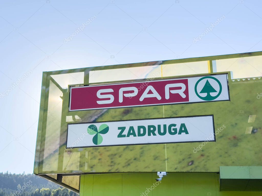 Bleiburg, Austria - September 19, 2025: SPAR supermarket sign is visible against a bright blue sky, highlighting the brand's identity and contemporary design