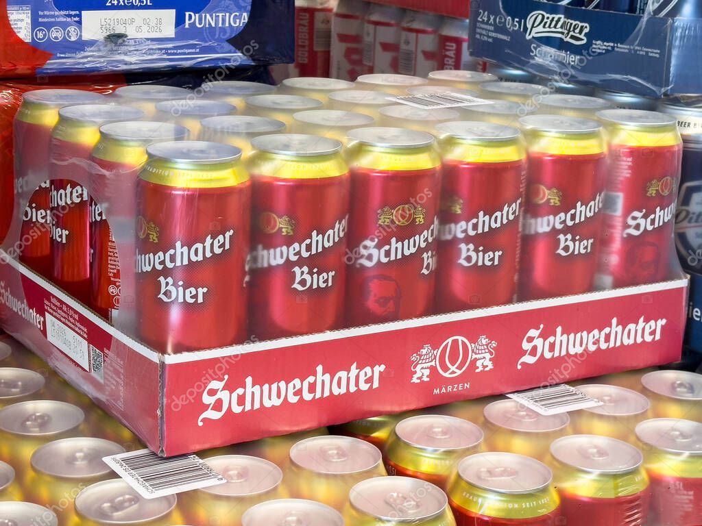 Bleiburg, Austria - September 19, 2025: Schwechater Bier cans arranged in a vibrant display, highlighting the colorful packaging and branding in a retail setting