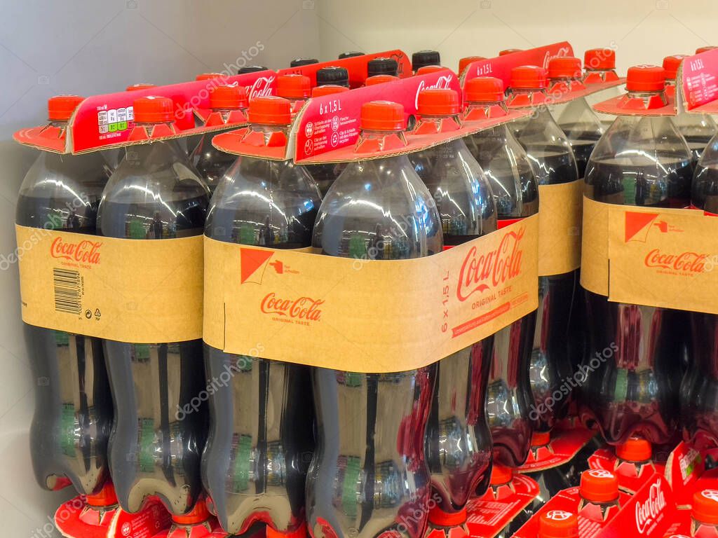 Bleiburg, Austria - September 19, 2025: Coca-Cola bottles displayed on a grocery store shelf, highlighting the recognizable brand and packaging design