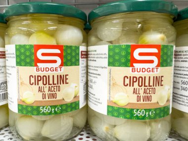 Gemona, İtalya - 24 Eylül 2025: Sirke içindeki ucuz cipolline soğanlar, çekici ambalajlarını ve aşçılık cazibelerini ön plana çıkaran bir rafa yerleştirilmiştir