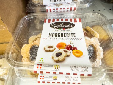 Gemona, İtalya - 24 Eylül 2025: Kiraz ve kayısı dolgulu Margherite kurabiyeleri bir mağaza rafında açık bir şekilde düzenlenmiştir