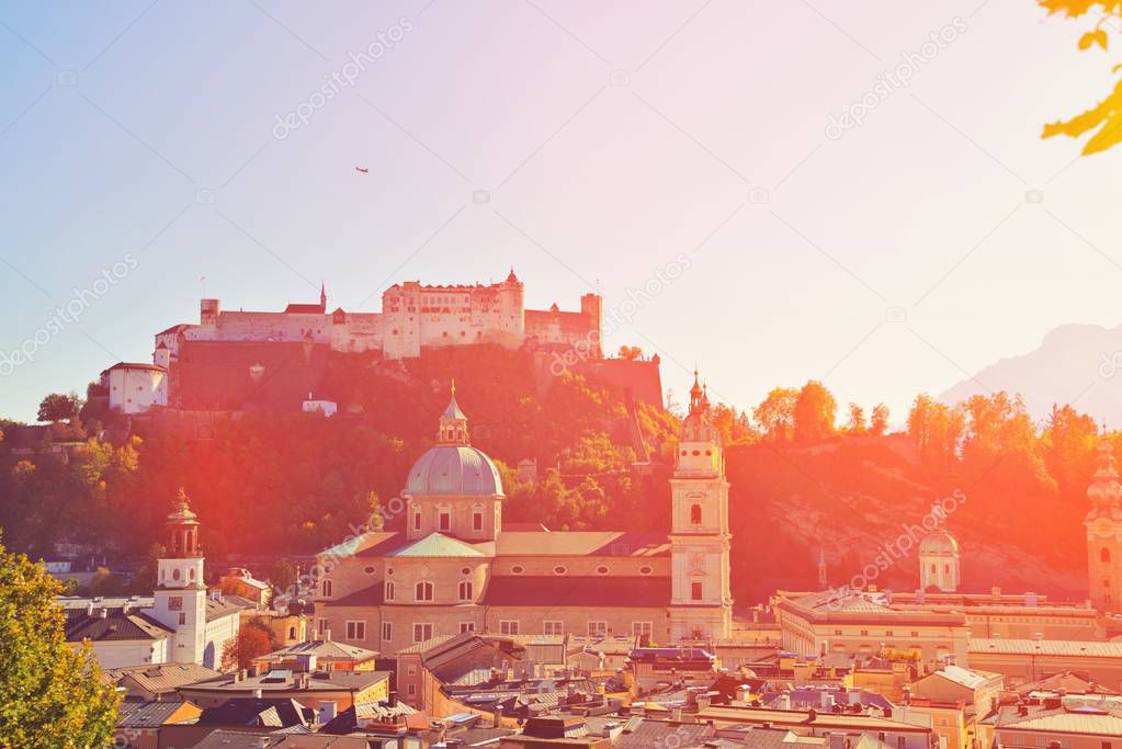 Salzburg, Austria. Sunset scenery in summer spring from above. View of the historic city of Salzburg with Salzburg Cathedral and famous Festung Hohensalzburg in autumn Salzburger Land.