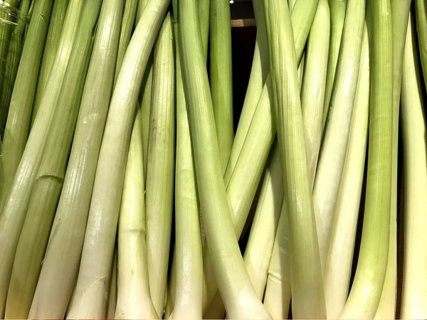 Green onions. Vegetables. Fragment from a fruit and vegetable shop.