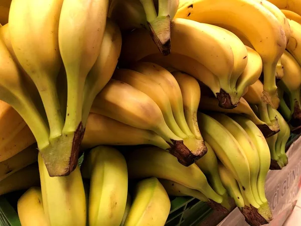 Natural fruits, vegetables, natural vitamins. Bananas. For sale in the market. A living fragment from a fruit and vegetable store.