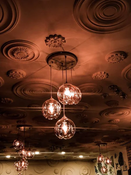 Lighting from the ceiling. Chandeliers and old ceiling.   Beautiful lighting.