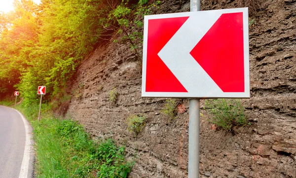 road sign turn left in the mountains