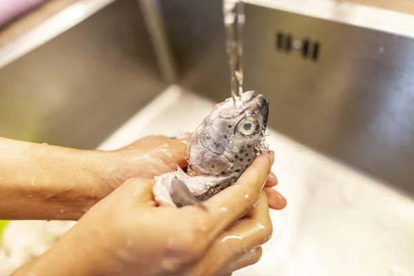 Een Mens Wast Een Verse Vis Onder Water — Stockfoto