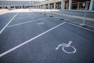 BERLIN / GERMANY - APRIL 29, 2018: Disabled parking space on Passenger terminal Berlin Brandenburg airport, Willy Brandt. The BER is an international airport under construction. clipart