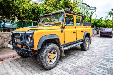 Sarı offroad araç bir sokakta duruyor