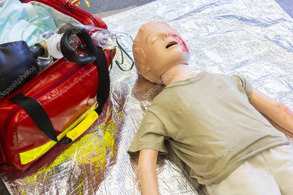 Medical teenager puppet lies injured on the ground