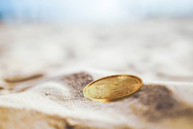 bir altın bitcoin kuma yatıyor