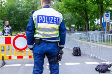 Hannover/Almanya-25 Mayıs 2019: Alman polis memuru bir sokakta bir etkinlik sağlamak için duruyor. Alman Polizei kelimesi, polis anlamına gelir..
