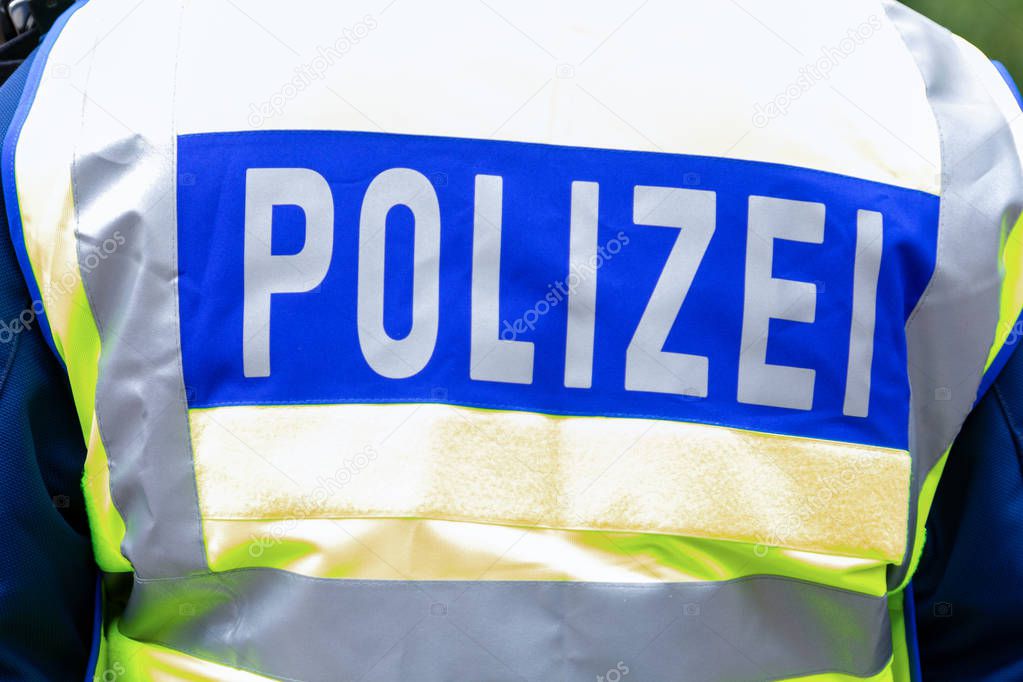 German police emblem weared by an officer. The german word Polizei, means police.