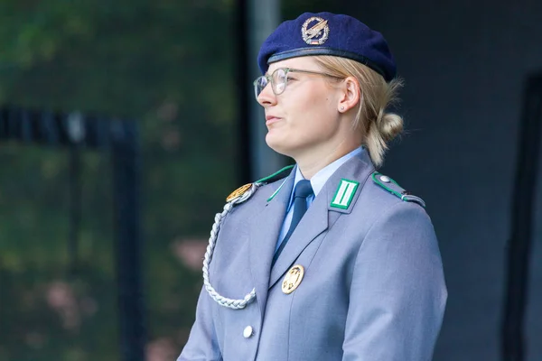 AUGUSTDORF / GERMANY - JUNE 15, 2019: German female soldier in full dress uniform walks on a stage at Day of the Bundeswehr 2019.