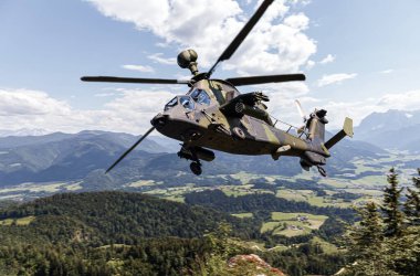 German attack helicopter flies over german landscape clipart