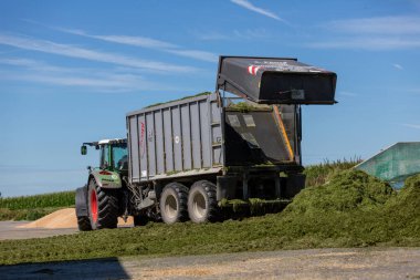 BAVARIA / GERMANY - 20 AĞUSTOS 2020: Yükleyici vagonlu Fendt traktörü, bir biyogaz fabrikasında çalışıyor