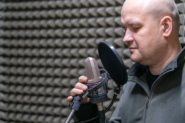 man radio DJ speaks into microphone close-up