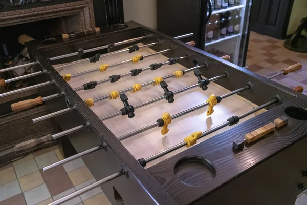 table football with black with yellow players close-up, table football game for stress relief and entertainment