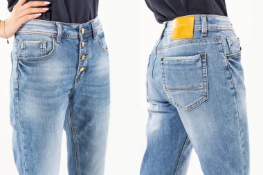 Kotlu kız beyaz arka planda kot pantolon gösteriyor. Kapalı, kot pantolon giyiyor.