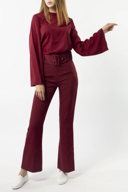 a girl in a red pantsuit on a white background clipart