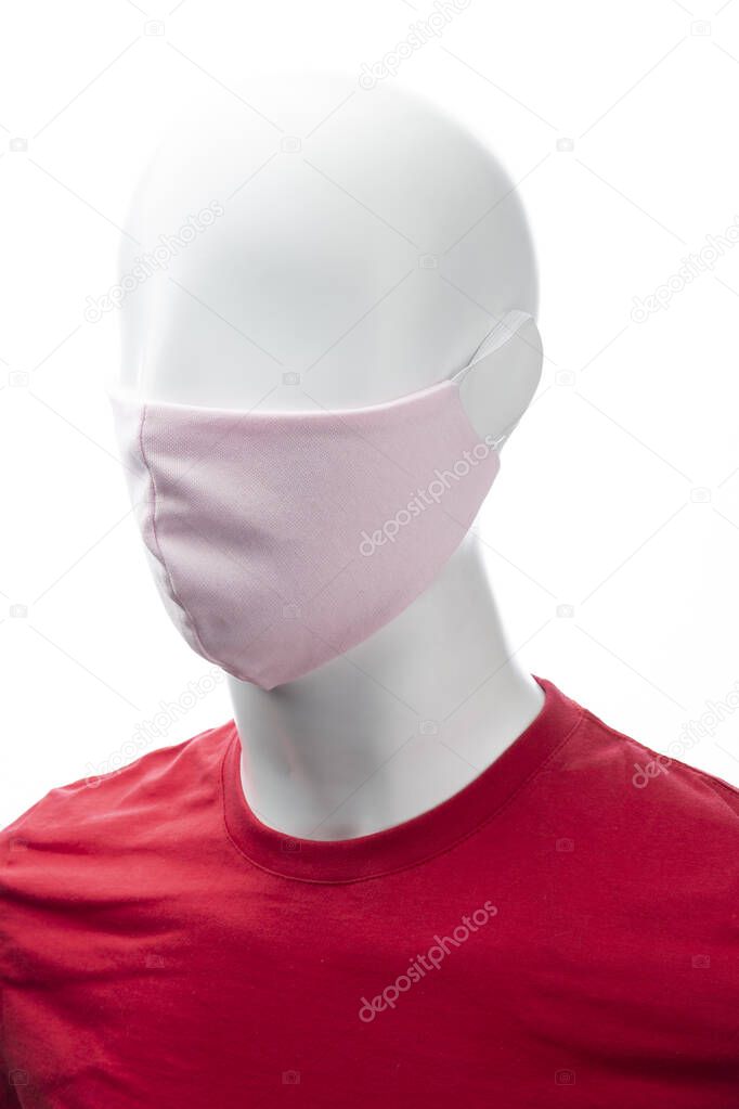 protective face mask against coronavirus on the face of a mannequin, pink color isolated on a white background