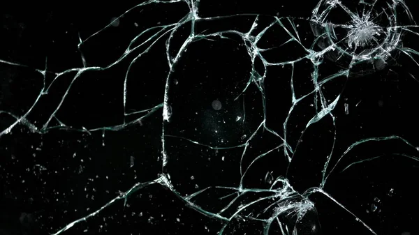 Shattered and broken glass pieces isolated on black — Stock Photo, Image