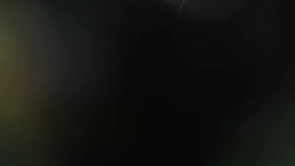 Real lente flare tiro no estúdio sobre fundo preto — Fotografia de Stock