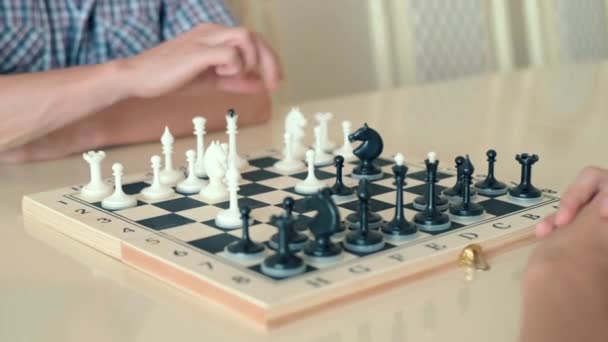 Ευτυχισμένο παιδί παίζοντας σκάκι με έναν ανώτερο άντρα στο σπίτι. — Αρχείο Βίντεο
