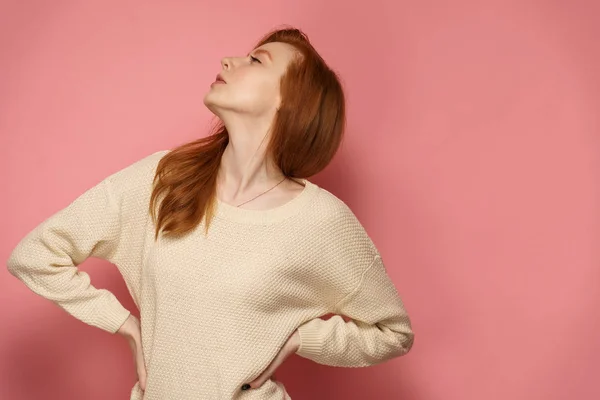 Young redhead woman tosses her head proudly with her hands on he — 스톡 사진