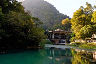 Bir ormanın ortasında bir dağın eteklerinde bir gölün üzerinde eski terk edilmiş bir istasyon binası.