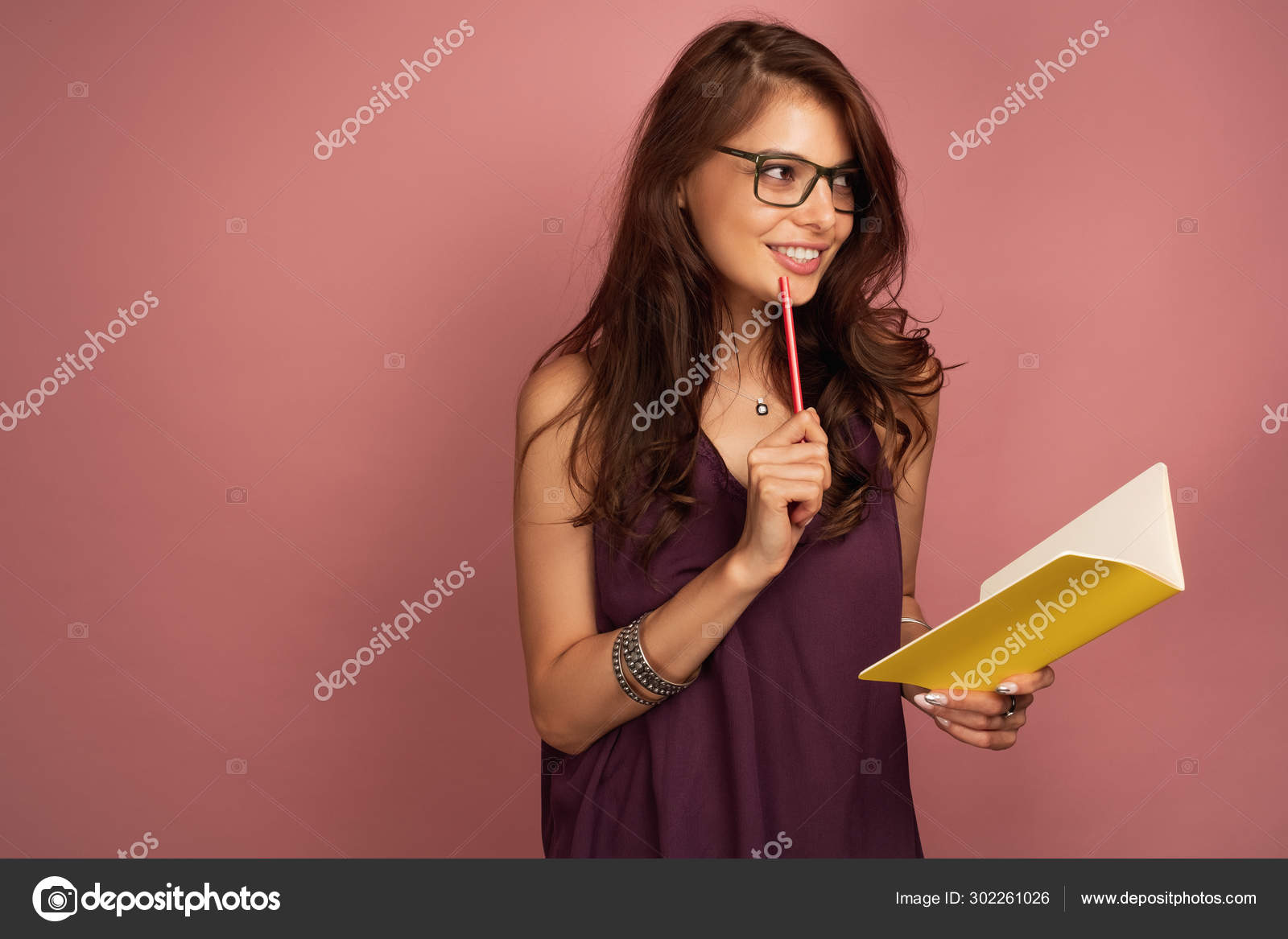 A Girl In A Purple Top And Glasses Stands Half Turned On A Pink