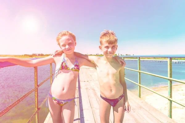 Brother Sister Stand Embrace Summer Swimsuits Wooden Bridge Sea — Stock Photo, Image