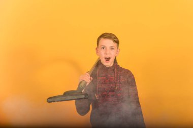 Sarı bir arka planda duman elektrikli süpürge ile bir adam