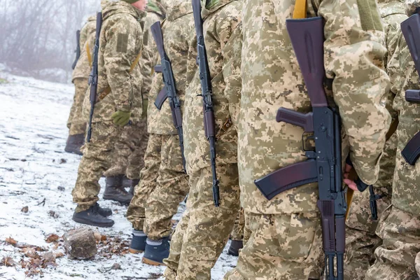 Story of military in camouflage with a firearm in winter