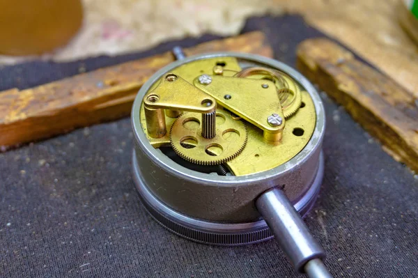 Disassembled dial gauge in the workshop under repair