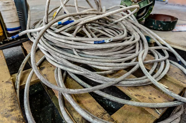 Thick powerful white cable and old transformer welding machine with copper winding