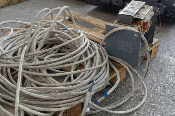 Thick powerful white cable and old transformer welding machine with copper winding