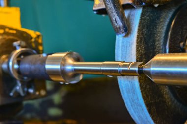 Demir silindirik bölümü bir taşlama monte edilmiş makine, yakın çekim