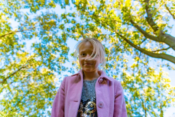 Girl Pink Coat Looks Camera Top Background Trees Park — Stock Photo, Image