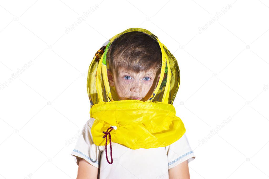A boy in a yellow mask from bees on an isolated background.