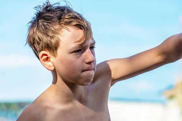 少年はビーチで ビーチでボクシングに取り組んでいます 彼はこぶしで梨を打つ — ストック写真