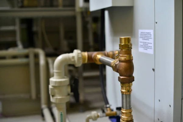 Brass, metal and plastic pipe joints under pressure at the station.