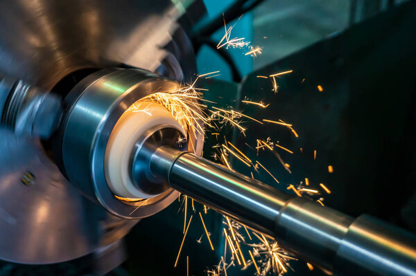 Internal processing of the hole with an abrasive stone on a grinding machine, sparks fly in different directions.