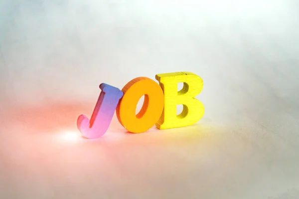 Multi-colored letters of the word work on a light background with backlight. — Stock Photo, Image