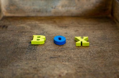 Kutu, ahşap renkli harfler, tahtadaki metin. Hacimsel harfler.