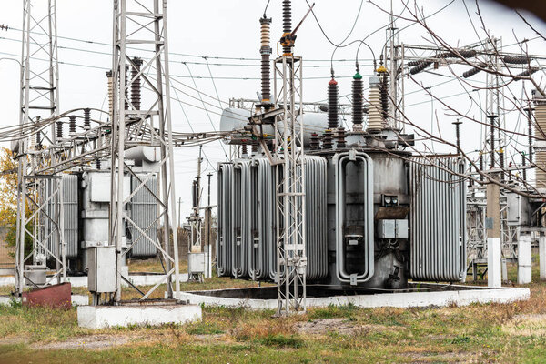 City power substation, close-up, transformer with high-voltage wires.