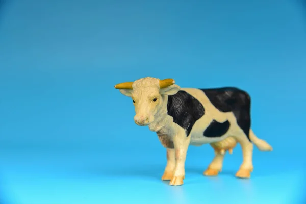 Toy animals made of plastic on a blue background, baby little animals.