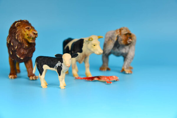 Toy animals made of plastic on a blue background, baby little animals.