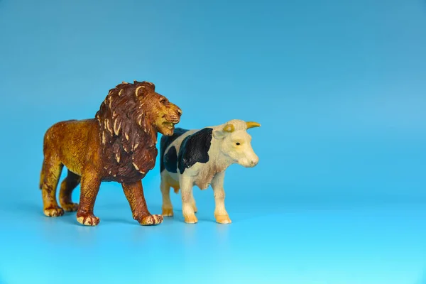 Toy animals made of plastic on a blue background, baby little animals.